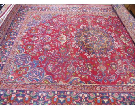 A Large 20th Century Persian Wool Carpet,  jewel colours of intricate foliate and eternal flame design, some wear evident, ap