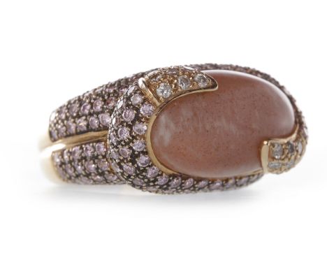 EIGHTEEN CARAT GOLD QUARTZ AND DIAMOND DRESS RING
set with a large oval section of pink quartz to a pave diamond setting and 