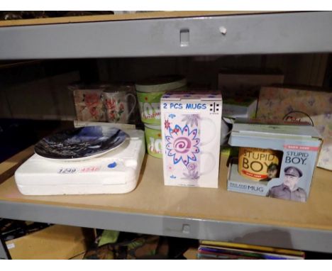 Shelf of boxed mugs and plates to include a Dads Army "Stupid Boy" mug. Not available for in-house P&amp;P