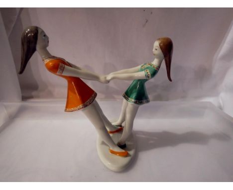 Hollohaza figure of two girls dancing 9A/F0 with a continental figure of two boys pushing a boat, largest 18cm. UK P&amp;P Gr