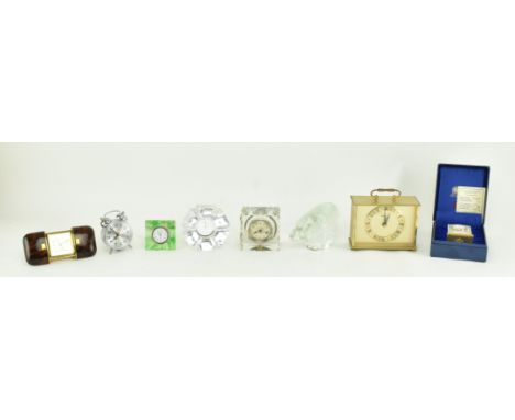 A collection of vintage 20th century travel clocks, including glass examples and a Pukeberg paperweight. The lot comprising a