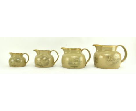 A collection of four early 19th century graduated drabware pottery jugs. Each jug on cream-tan ground with gilt rim, featurin