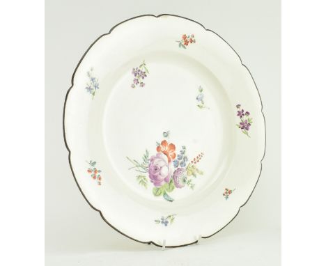 An 18th century likely continental porcelain charger plate. The plate of white ground with painted rim and light floral decor