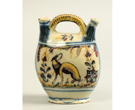 An early 19c Southern European Faience flask with two spouts and central carrying handle, painted in red, black, yellow and m