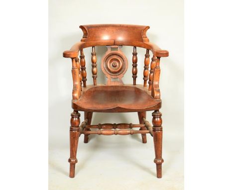 A Victorian mahogany elm seated bow back armchair with baluster ring turned supports, having a central roundel splat with sad