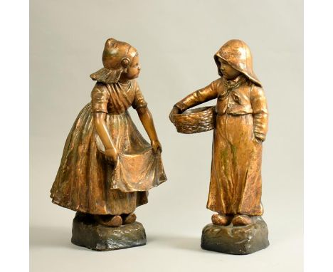 A pair of early 20c Goldscheider gilt decorated figures modelled as a Dutch boy and girl, signed and no.2994 and no.2995, 15.