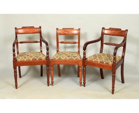A set of ten (8+2) Regency mahogany rope twist dining chairs with carved and shaped panel top rails, rope twist splat on ring