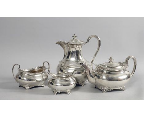 A George V four piece silver tea service of compressed ovoid form with shaped upper rims and scrolling handles, the teapot 10