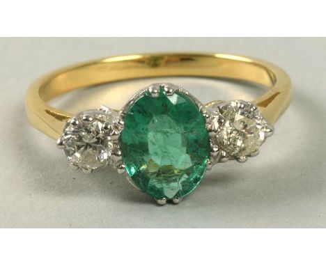 An 18ct emerald and diamond set ring.