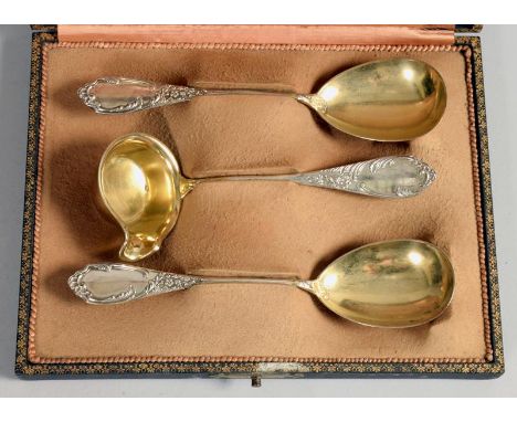 An early 20c German silver three piece serving set comprising of a pair of spoons with gilt lined oval bowls and one lipped l