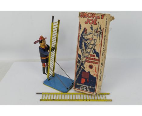 Smokey Joe - Louis Marx & Co LTD. A boxed tinplate clockwork Smokey Joe, the climbing fireman, in original box in poor condit