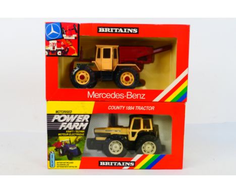 Britains. Two boxed Britains Tractors appearing in VG condition in Good boxes. #9324 County 1884 Tractor. #9597 Mercedes Benz