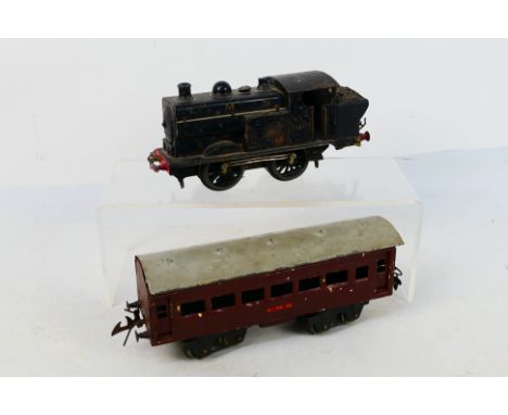 Stronlite - A rare pre war Japanese O gauge Stronlite 0-4-0 tank engine in LMS livery number 7001 and a Stronlite coach. They