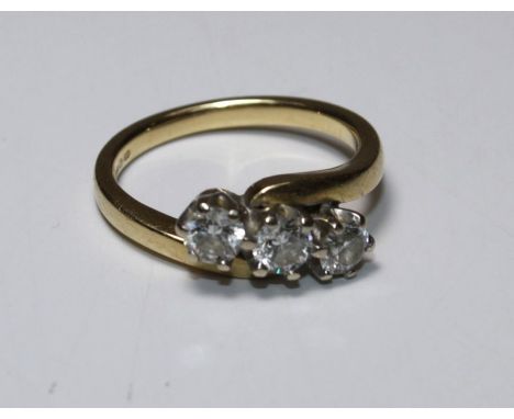 An 18ct three stone diamond ring, claw set three brilliant cut diamonds, total diamond weight approx. 0.50ct, 4.5g