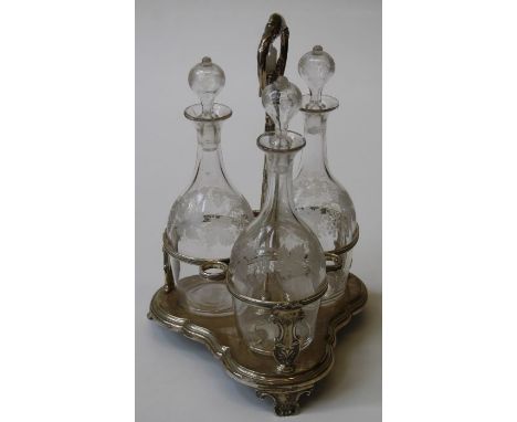 K and W, a William IV silver spirit decanter stand with florally cast ring handle and reeded retainers, on trefoil base and s