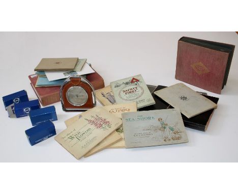 A box containing cigarette cards, boxed die cast toys and barometer