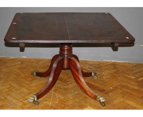 A married George III mahogany breakfast table, the rectangular tilt top with a reeded edge, on a ring turned column, four ree