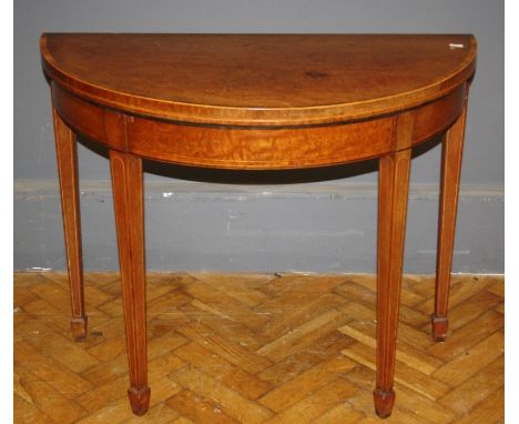 A George III figural mahogany and crossbanded card table, the foldover top raised on tapered legs, W92cm