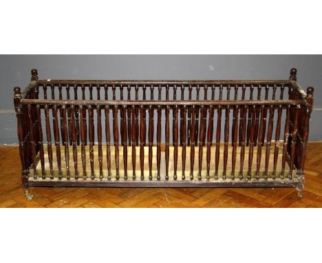 A 19th century walnut hall stick stand of large size, the oblong shape having a galley of turned supports raised on castors, 