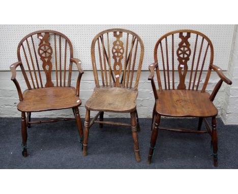 A near pair of late 19th century elm seated wheel and stick back carver chairs and a similar standard chair (3)