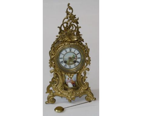 A late 19th century/ early 20th century French gilt metal mantle clock, the Rococo balloon case, enclosing an eight day bell 