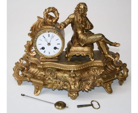 A late 19th century French gilded spelter mantle clock with figural surmount beside a drum case enclosing a bell striking mov