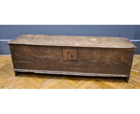 A late 17th/early 18th century oak panel coffer, raised on cut panel dual end supports, W133cm