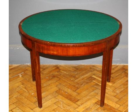 A late George III mahogany card table, the demi lune foldover top raised on tapered legs, W95cm