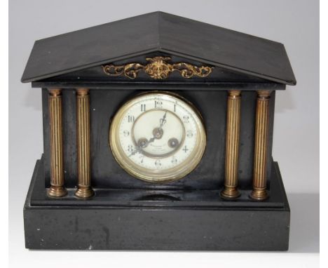A late 19th century French mantle clock, the gilt metal applied four column slate case enclosing an eight day gong striking m