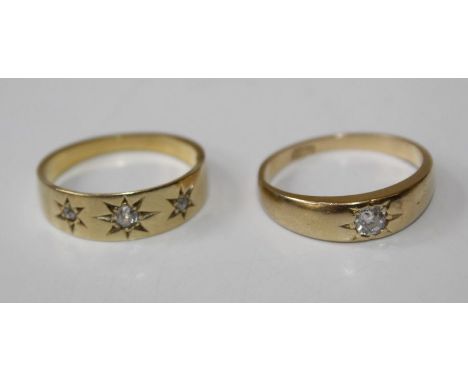 A pair of dress rings, gypsy set with diamond, one single stone, size K, stamped 18ct and tests accordingly. The second three