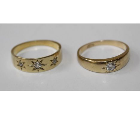 A pair of dress rings, gypsy set with diamond, one single stone, size K, stamped 18ct and tests accordingly. The second three