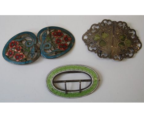 A pair of silvered buckles inlaid with shamrock W5cm, an oval green and white enamel buckles and another pair of enamel buckl