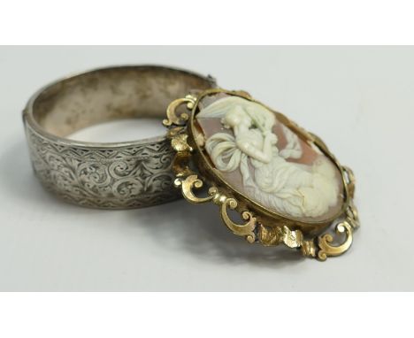 Silver ornate bangle, 32.7g and Antique: large oval cameo brooch (some losses) (2) 