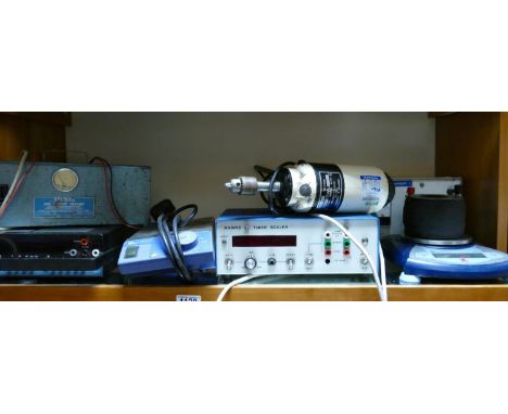 A collection of scientific items suitable for steampunk builds including: scales, power supplys, bench mounted drills, timer,