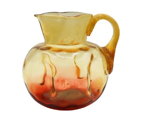 Amber and orange colored hand-blown pitcher, appears to be unsigned.Size: 5 x 6 x 4 1/2 in.