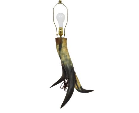 Western lamp, mounted horn with a unique tri footed form. Size: 29 x 13 in. Please note that all sales are final. No refunds 
