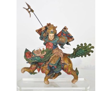 Costumed warrior with weapon, on a running animal figure. Ceramic tiles such as this one have been placed on Chinese temple r