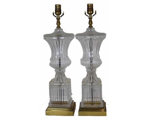 Two matching vintage stand lamps of colorless flint glass, hollow stem and base, brass mounts. Unknown as to working conditio