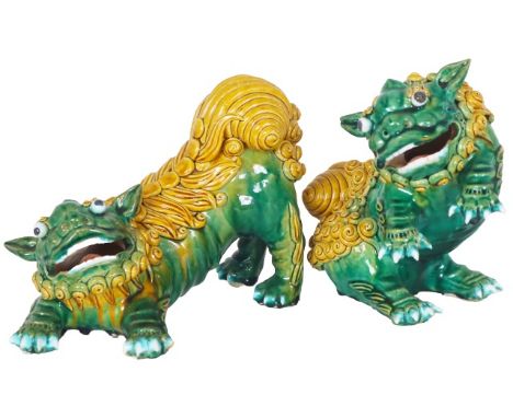 Two expressive ceramic foo dogs, brightly glazed in green and yellow ochre, hollow mouths opened.Approx. size: 8 x 9 in. and 