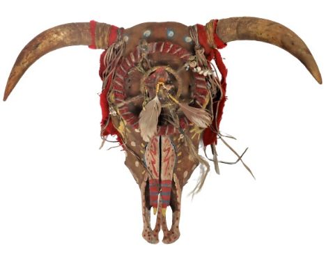 Elaborately decorated animal skull, design appears to be American Indian. Painted with natural pigmented colors, ornamented w