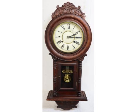 This is a lovely wooden wall hanging clock with painted glass door and pendulum. Size: 31 x 12 1/2 x 5 1/2 in.