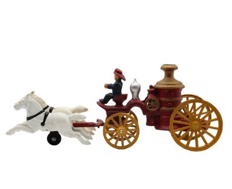 Vintage reproduction painted cast iron toy of a fireman's cart in motion, consisting of a rider on the cart pulled by two hor