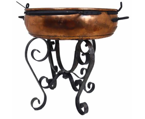 Very large copper pot or cauldron, sits atop wrought iron stand, made in Mexico 2001.  Shows definite signs of use. Comes wit