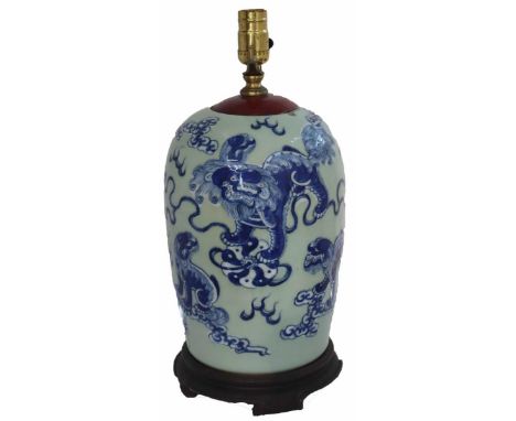 Chinese vase or jar mounted as a lamp, with blue and white foo dog motif, on wooden base. Unknown as to working order. Approx