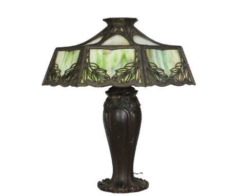Beautiful green tint stained glass lamp, in the style of Tiffany & Co. Nice detailing on the shade and sturdy base. Commensur
