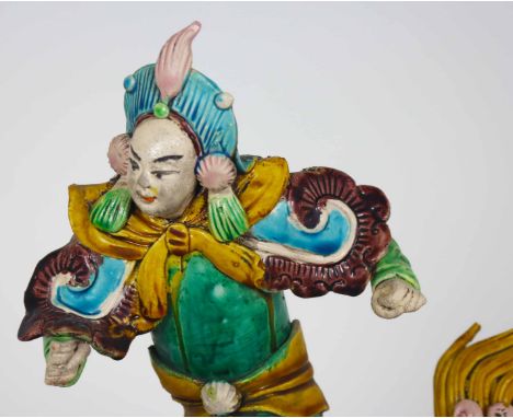 Chinese figure on a foo dog. Ceramic tiles such as this one have been placed on Chinese temple roofs for centuries to ward of