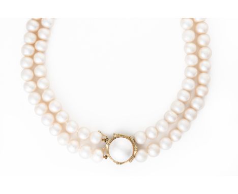 A TWO ROW NECKLACE OF FRESHWATER CULTURED PEARLSOn a gold and cultured pearl clasp, detailed 585 14 K, length 47.5cm, with a 