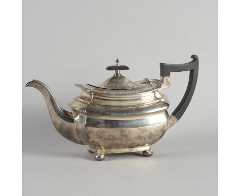 A SILVER TEAPOTDecorated with a gadrooned rim and raised on four bun feet, Sheffield 1926, gross weight 742 grams