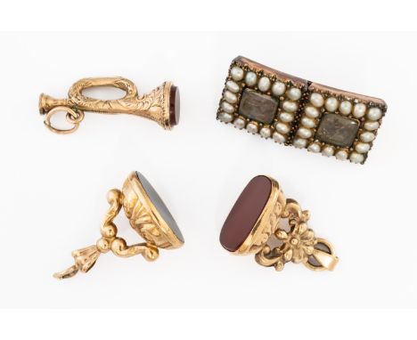 THREE PENDANT FOBS AND A BROOCH (4)Comprising; a 9ct gold and cornelian pendant fob, a 9ct gold and black onyx pendant fob, a
