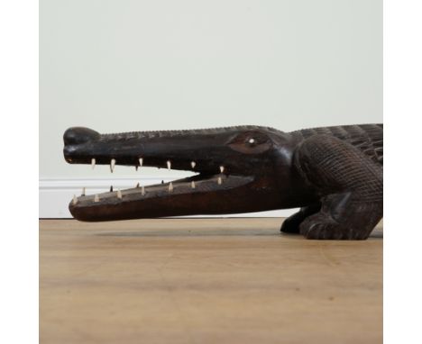 A LARGE TRIBAL STYLE CARVED HARDWOOD MODEL OF A CROCODILE190cm long